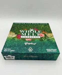 Whole Melt Extracts Tropical premium live resin sugar with golden crystalline texture, exotic fruity terpene profile, and lab-tested cannabis concentrate in sealed container