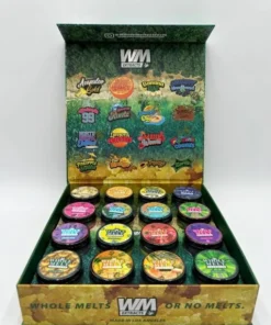 Whole Melt Extracts Tropical premium live resin sugar with golden crystalline texture, exotic fruity terpene profile, and lab-tested cannabis concentrate in sealed container