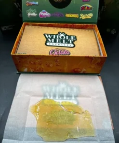 Whole Melt Banana Gelato premium shatter with golden glass-like texture, lab-tested cannabis concentrate, high-quality extract close-up view