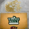 Whole Melt Skittlez shatter with golden glass-like texture, vibrant terpene-rich cannabis concentrate, lab-tested premium quality close-up