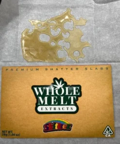 Whole Melt Skittlez shatter with golden glass-like texture, vibrant terpene-rich cannabis concentrate, lab-tested premium quality close-up